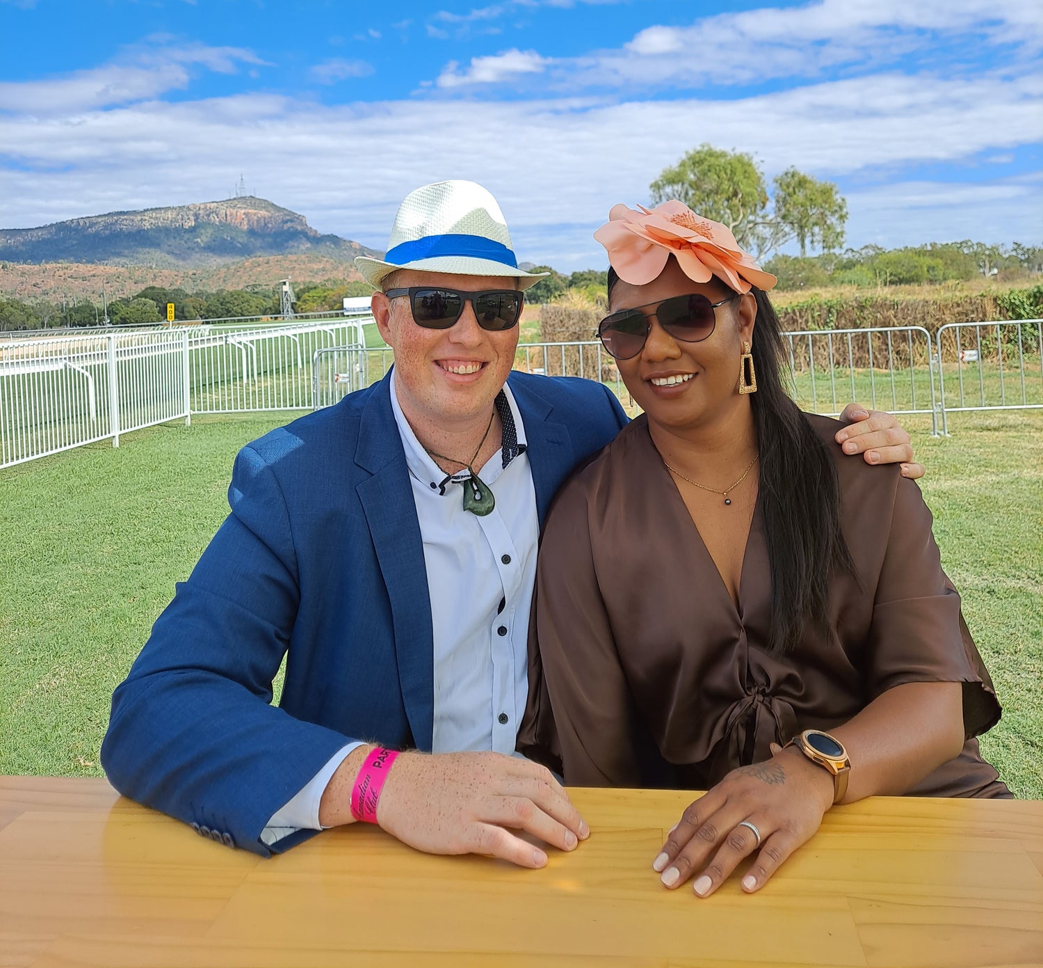 Two people sitting at a table outdoors with a scenic background